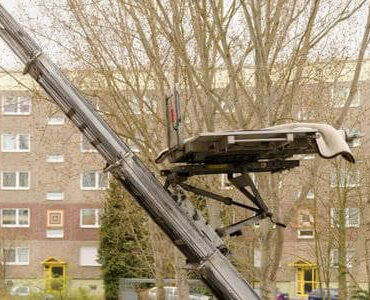 Schräg ausgefahrener Möbellift an einem Mehrfamilienhaus – Schrägaufzug